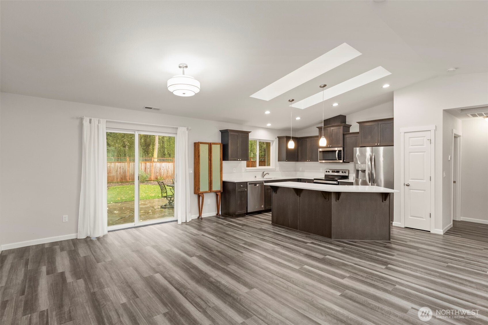174 East Island View Avenue Port Townsend, WA 98368 - Photo 14 of 39 a large kitchen with stainless steel appliances kitchen island a large counter top and a wooden floors