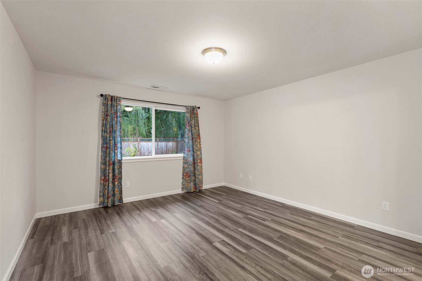 174 East Island View Avenue Port Townsend, WA 98368 - Photo 21 of 39 an empty room with wooden floor and windows