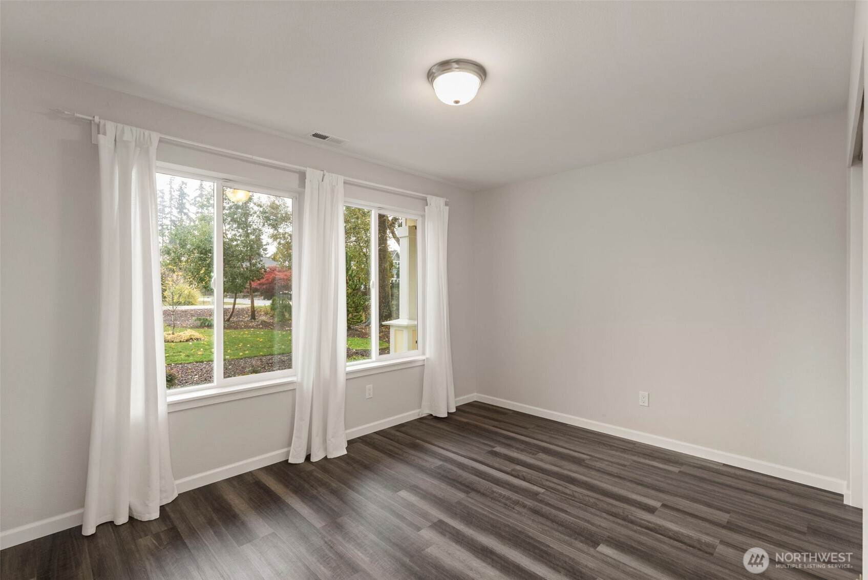 174 East Island View Avenue Port Townsend, WA 98368 - Photo 28 of 39 a view of an empty room with wooden floor and a window