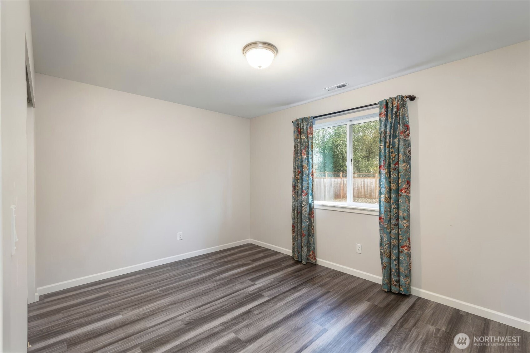 174 East Island View Avenue Port Townsend, WA 98368 - Photo 30 of 39 an empty room with wooden floor and windows