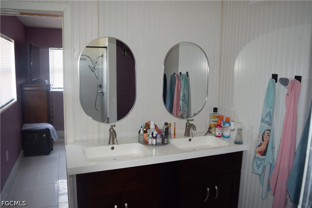 17 Colorado Road Lehigh Acres, FL 33936 - Photo 17 of 17 a bathroom with double vanity sinks and a mirror
