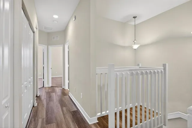 an aerial view of residential houses with outdoor space and lake view