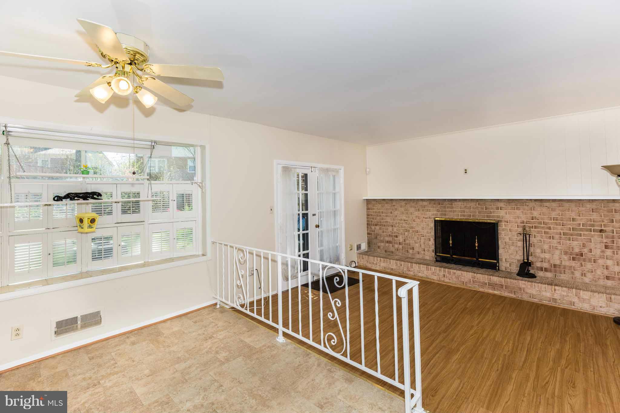 13405 Tamarack Road Silver Spring, MD 20904 - Photo 11 of 30 a view of livingroom with kitchen and dining area wooden floor fan