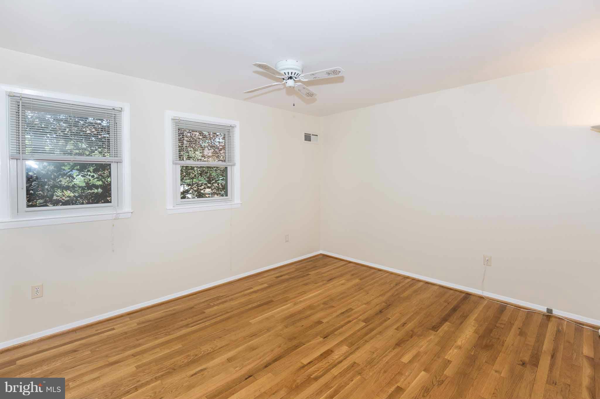 13405 Tamarack Road Silver Spring, MD 20904 - Photo 18 of 30 an empty room with wooden floor fan and windows