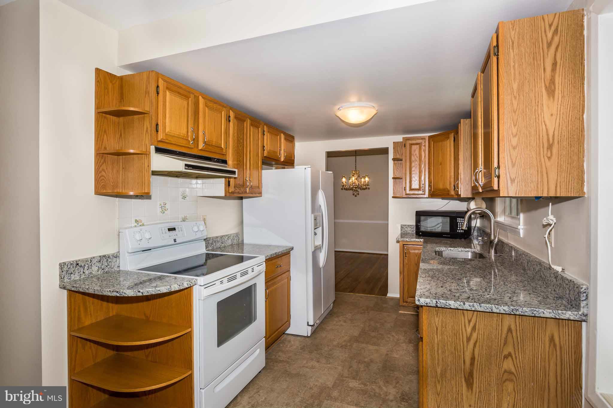 13405 Tamarack Road Silver Spring, MD 20904 - Photo 2 of 30 a kitchen with stainless steel appliances granite countertop a sink stove and refrigerator