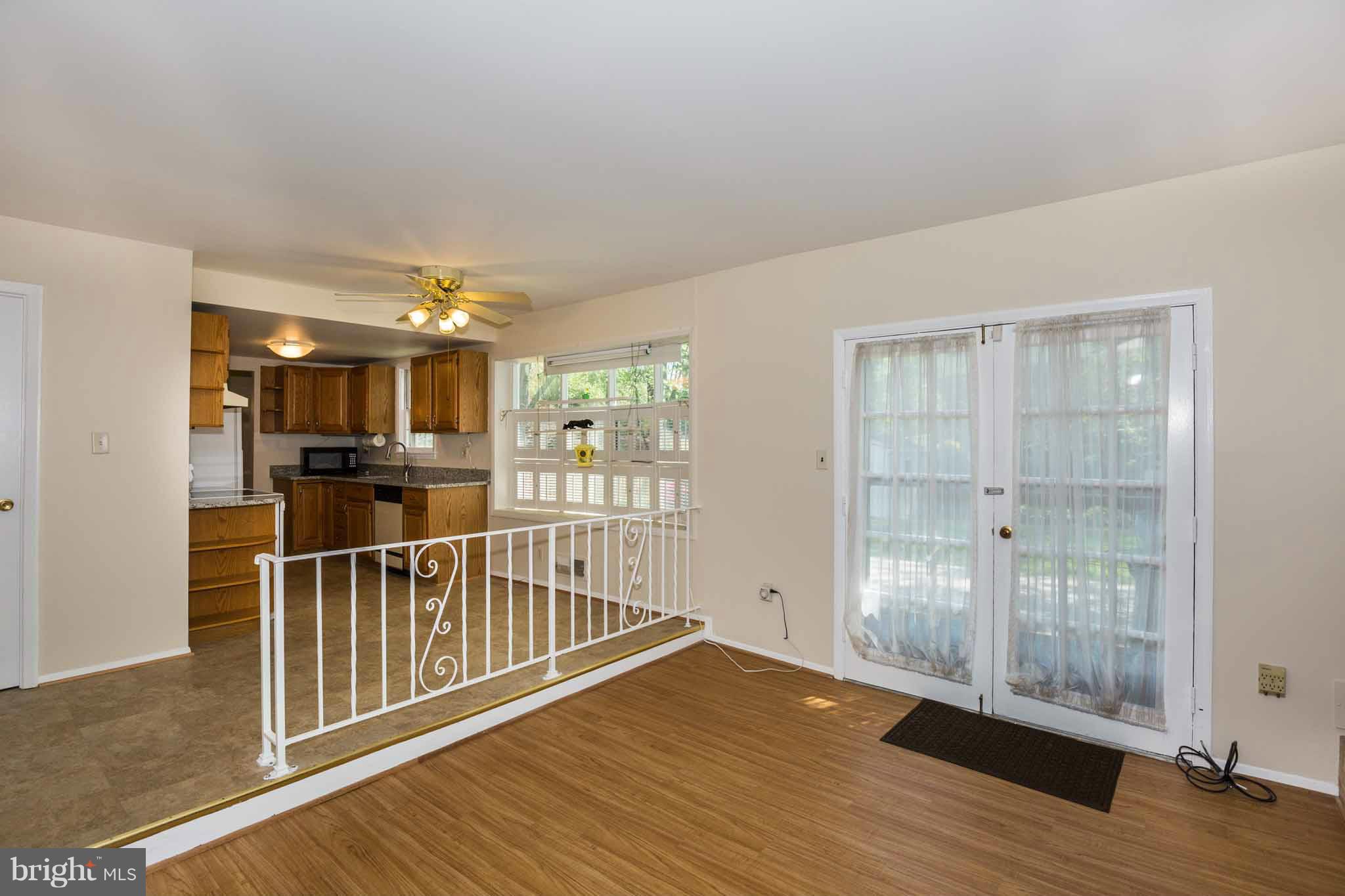 13405 Tamarack Road Silver Spring, MD 20904 - Photo 3 of 30 an empty room with wooden floor and windows
