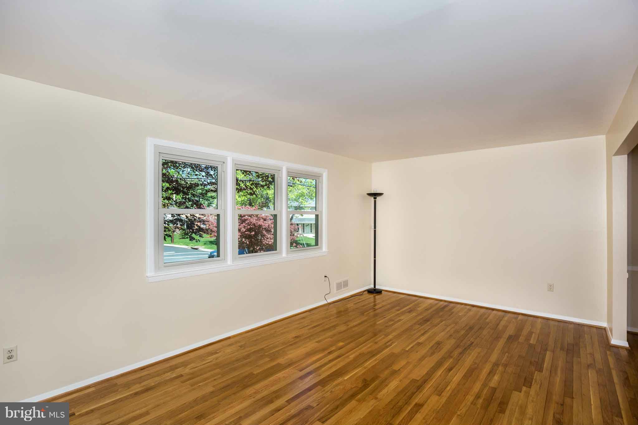 13405 Tamarack Road Silver Spring, MD 20904 - Photo 4 of 30 an empty room with wooden floor and windows