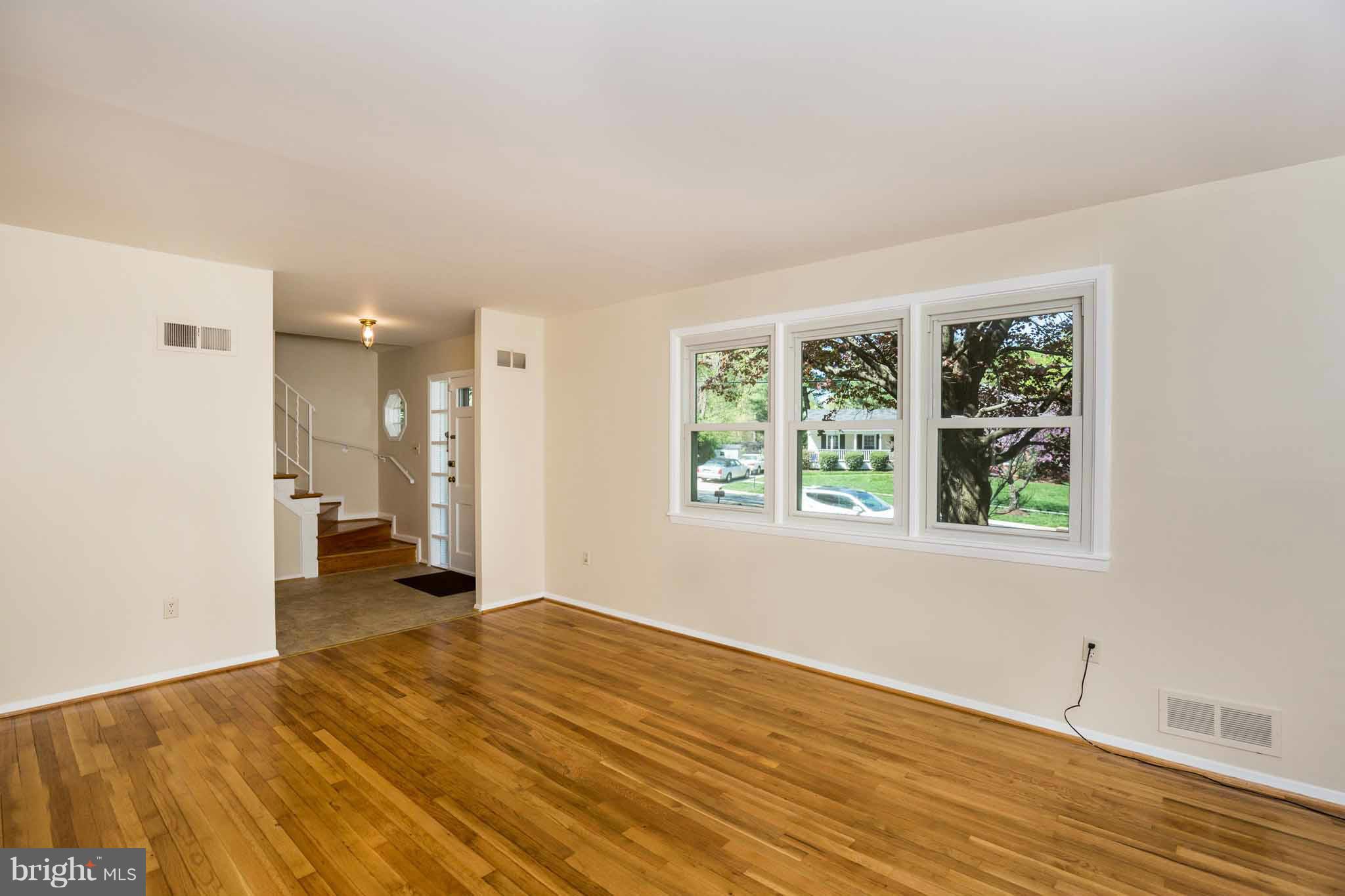 13405 Tamarack Road Silver Spring, MD 20904 - Photo 7 of 30 a view of an empty room with wooden floor and a window