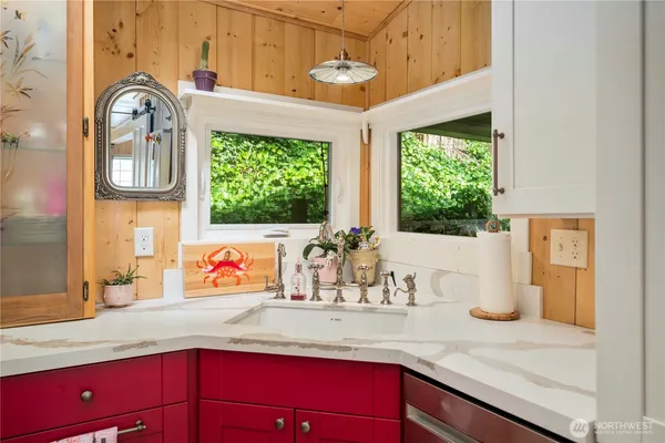 a kitchen with stainless steel appliances a sink a counter space and a window