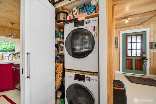 a utility room with dryer washer and a window