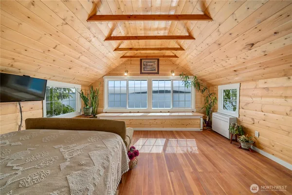 a spacious bedroom with a large bed and a large window