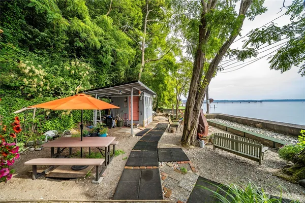 a view of a patio with couches under an umbrella
