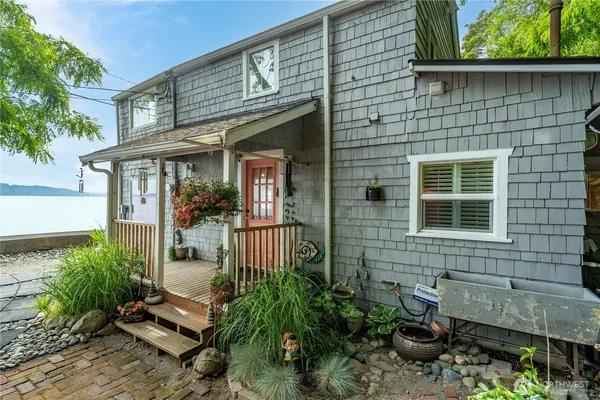 a front view of a house with a garden