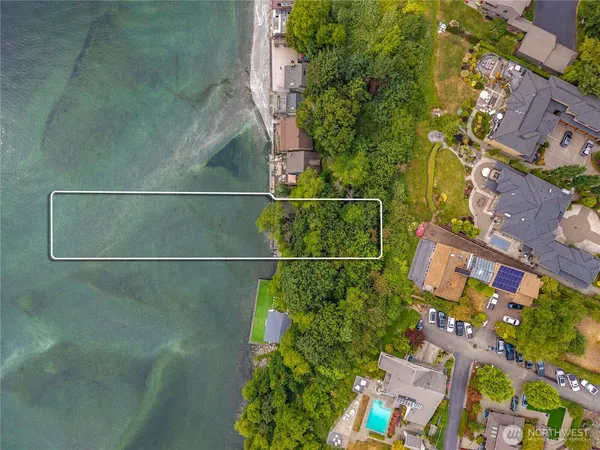 an aerial view of a houses with a yard