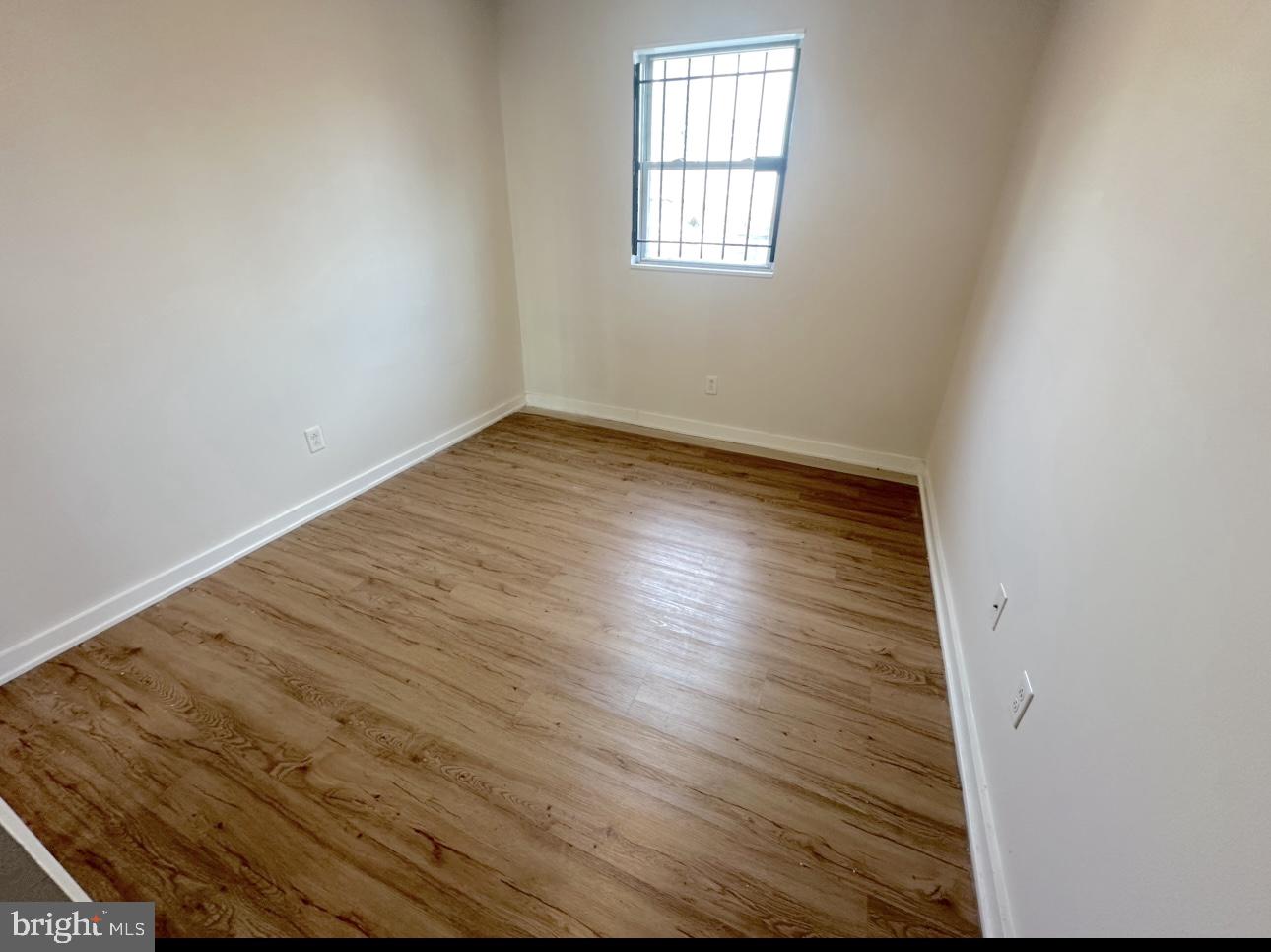 1324 North 17th Street, Unit 3 Philadelphia, PA 19121 - Photo 11 of 12 an empty room with wooden floor and windows