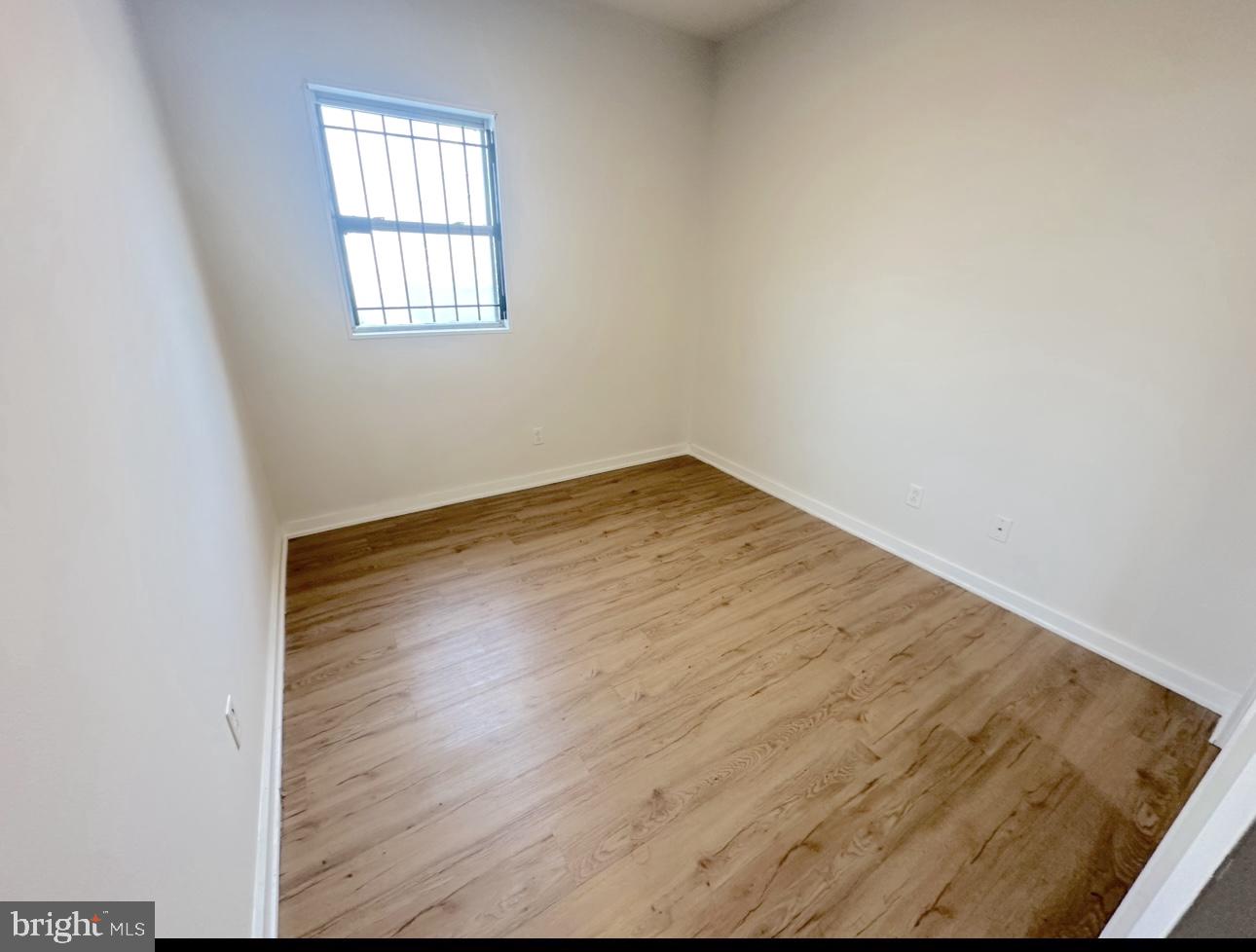 1324 North 17th Street, Unit 3 Philadelphia, PA 19121 - Photo 6 of 12 an empty room with wooden floor and windows