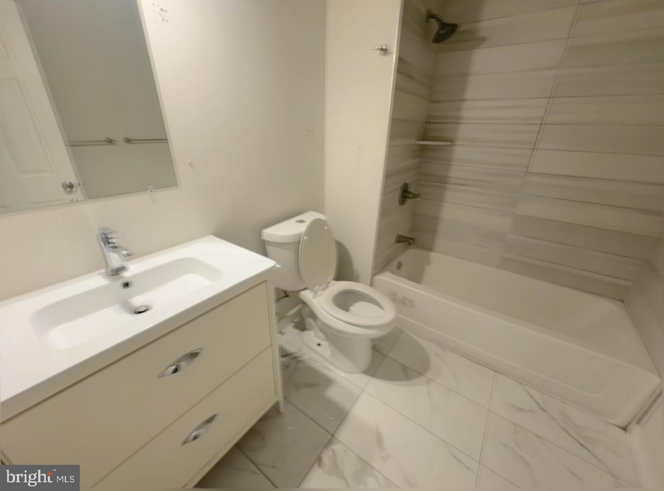 1324 North 17th Street, Unit 3 Philadelphia, PA 19121 - Photo 8 of 12 a bathroom with a sink a toilet and shower
