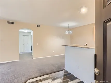 a view of a livingroom with a ceiling fan and window