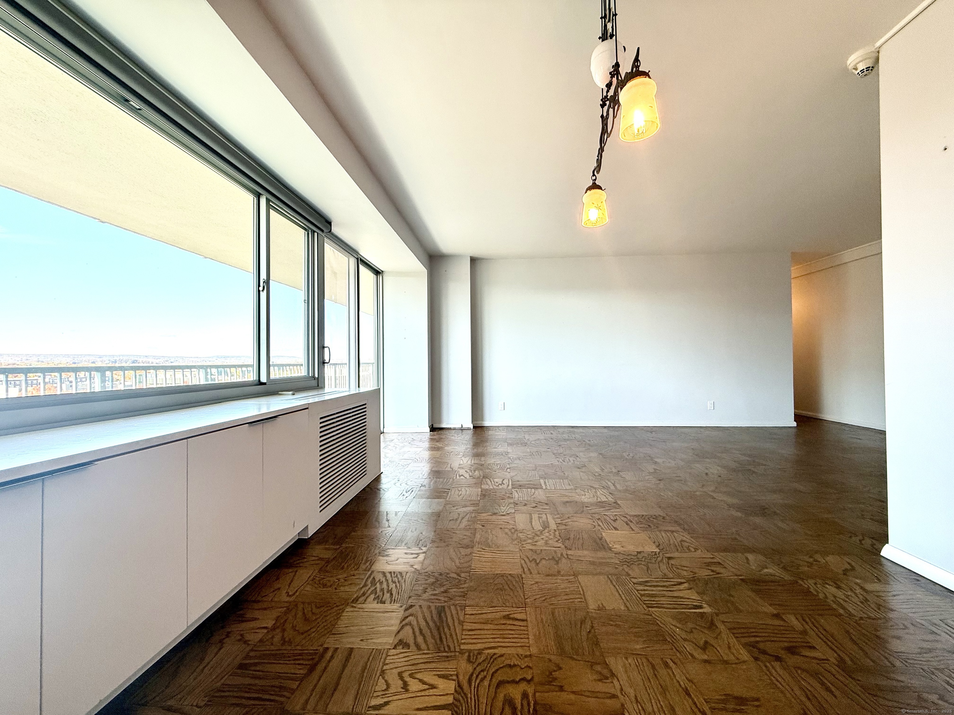 100 York Street, Unit 12S New Haven, CT 06511 - Photo 11 of 35 a view of an empty room with wooden floor and a window
