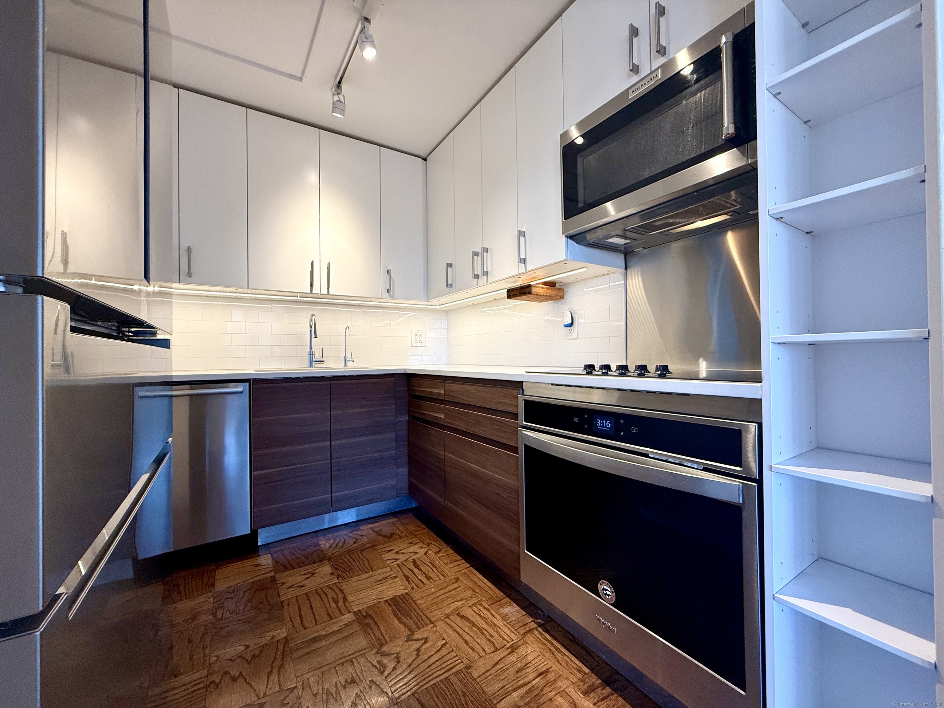 100 York Street, Unit 12S New Haven, CT 06511 - Photo 15 of 35 a kitchen with stainless steel appliances granite countertop a stove and a microwave