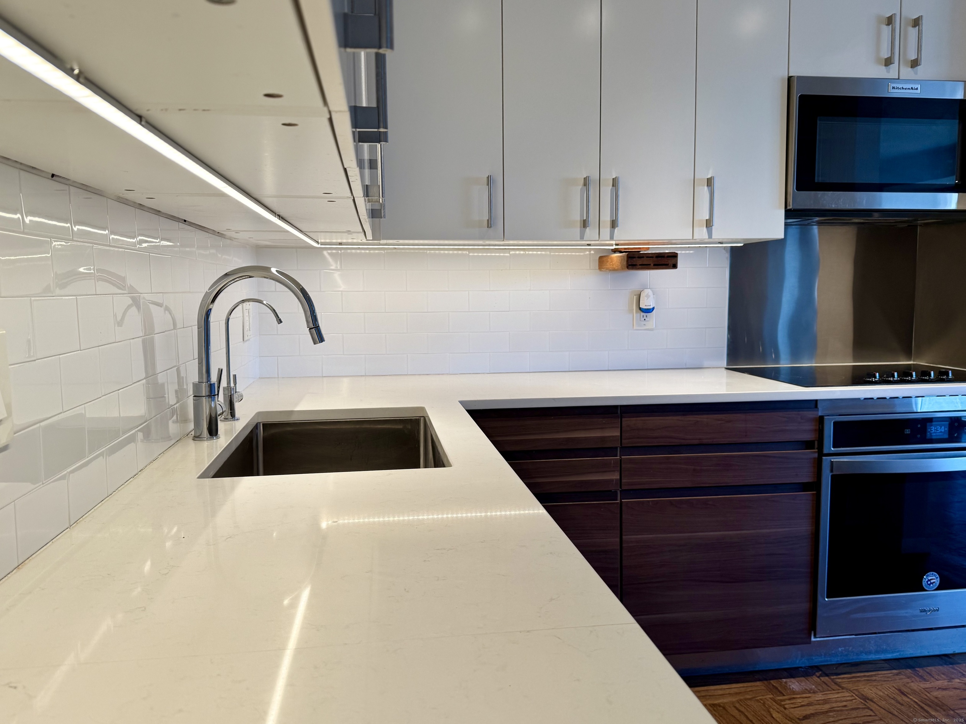100 York Street, Unit 12S New Haven, CT 06511 - Photo 19 of 35 a kitchen with sink a microwave and cabinets