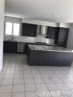 a kitchen with stainless steel appliances granite countertop a sink and a stove