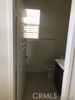 a bathroom with a toilet and a window