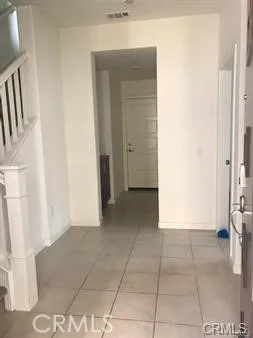 a view of a hallway to rooms