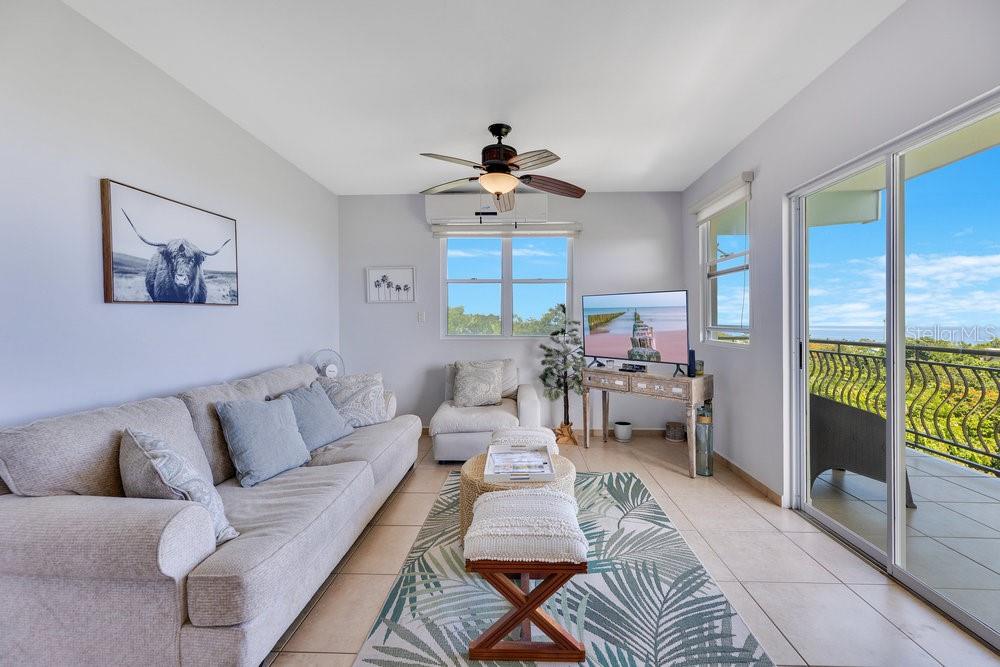 413 Camino Carretas, Unit A7 Rincon, Rincón 00677 - Photo 6 of 23 a living room with furniture and a large window