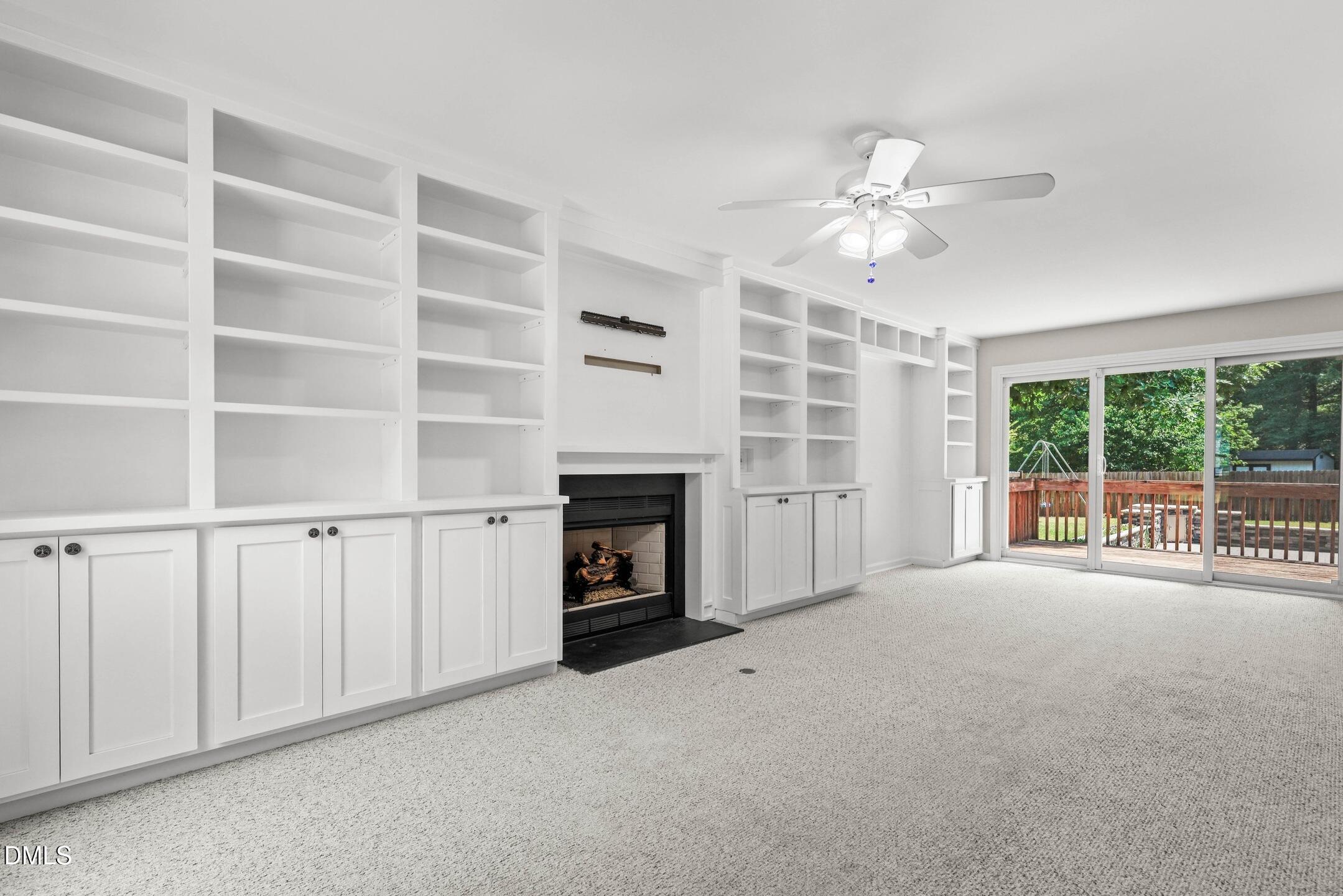 3015 Rennit Court Raleigh, NC 27603 - Photo 6 of 40 a view of an empty room with a fireplace and a window
