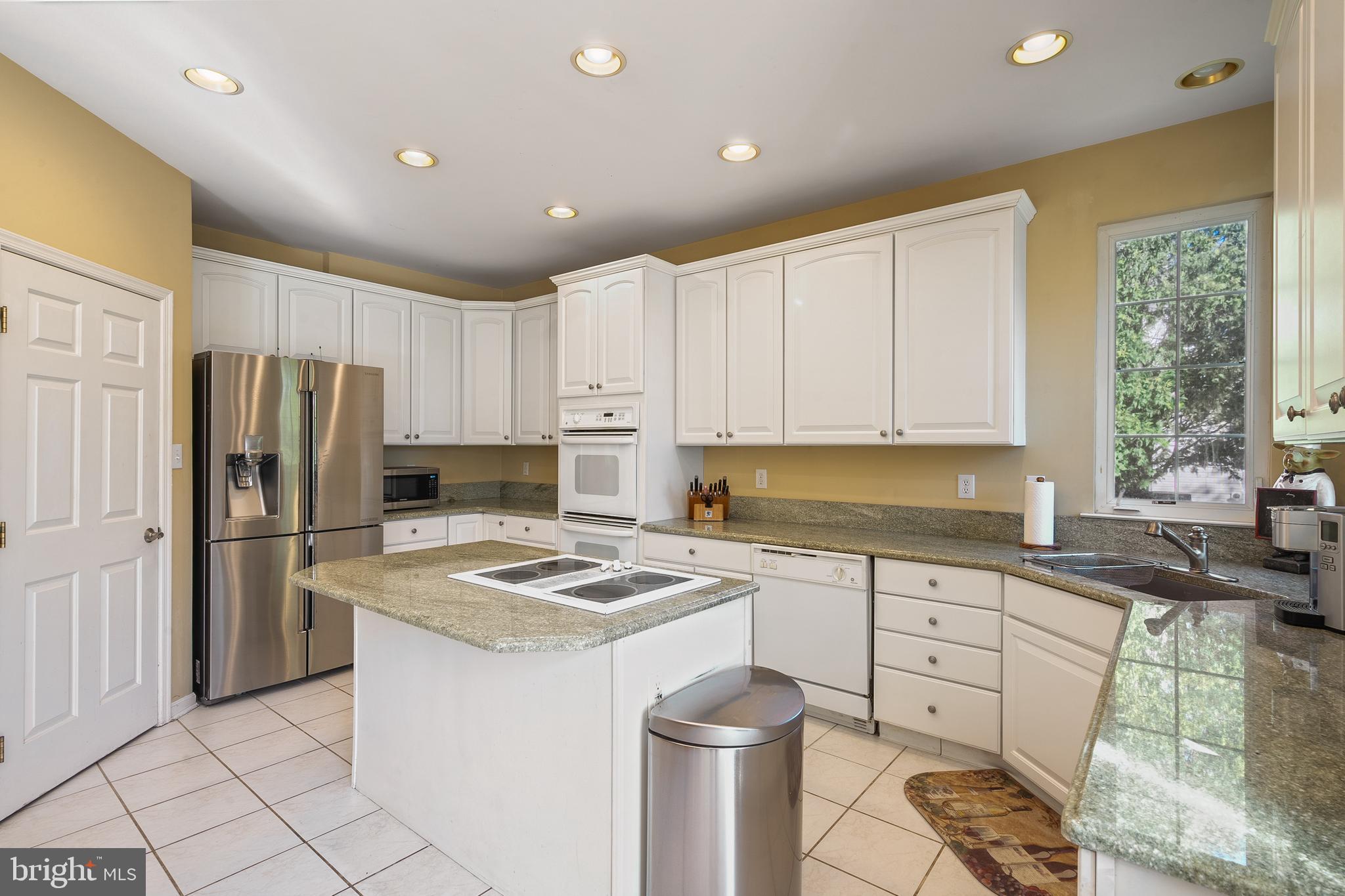 27 Donovan Road Pennington, NJ 08534 - Photo 19 of 60 a kitchen with a sink a stove a refrigerator a center island and cabinets
