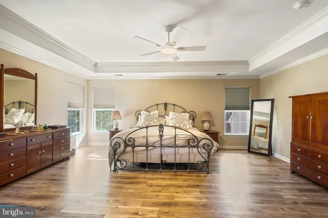 a spacious bathroom with a bathtub a double vanity sink a window and a mirror