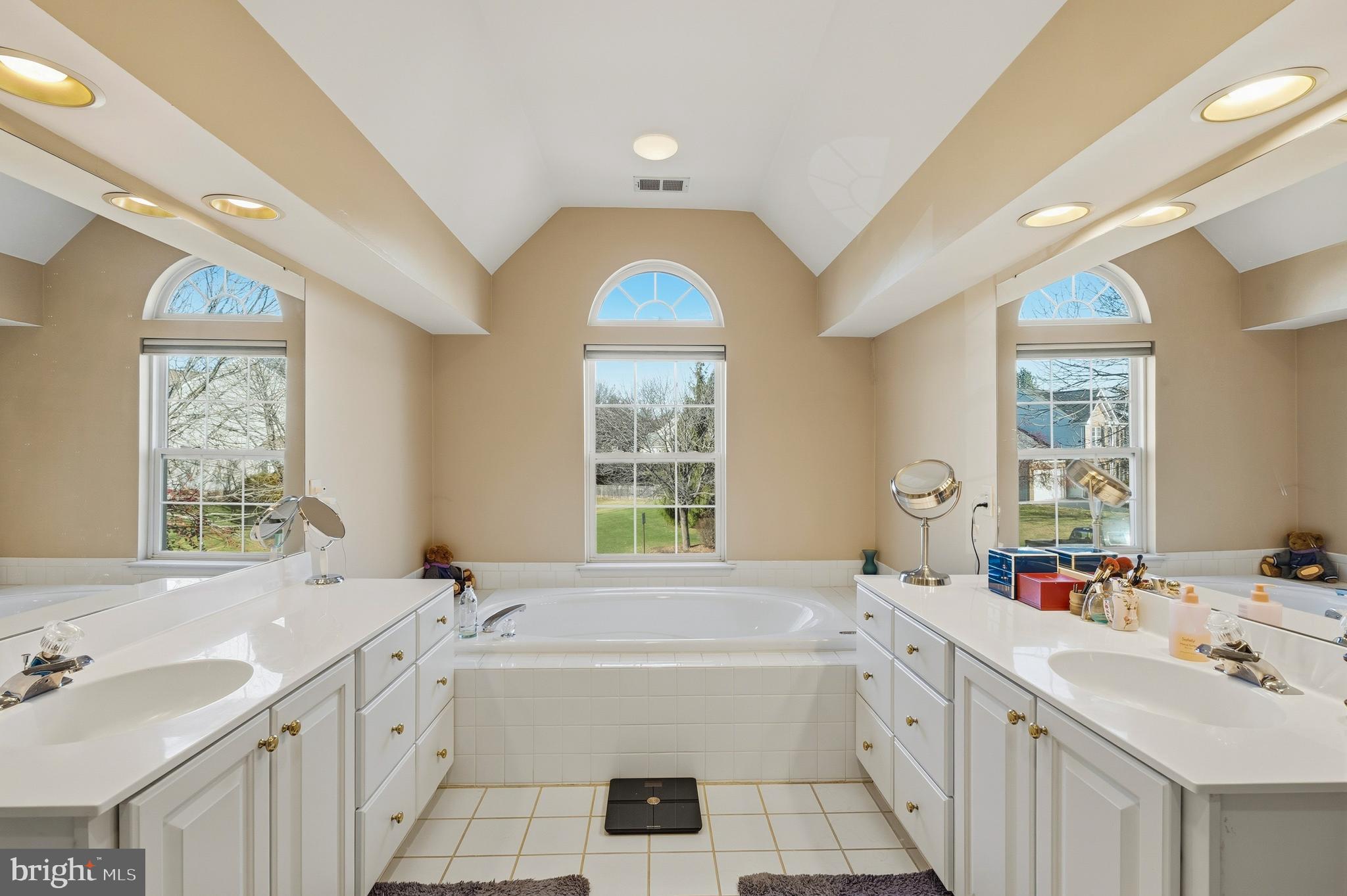 27 Donovan Road Pennington, NJ 08534 - Photo 31 of 60 a spacious bathroom with a bathtub a double vanity sink a window and a mirror