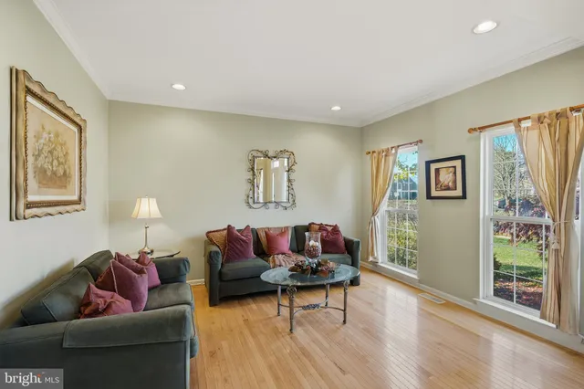 a view of a dining room with furniture a chandelier and wooden floor