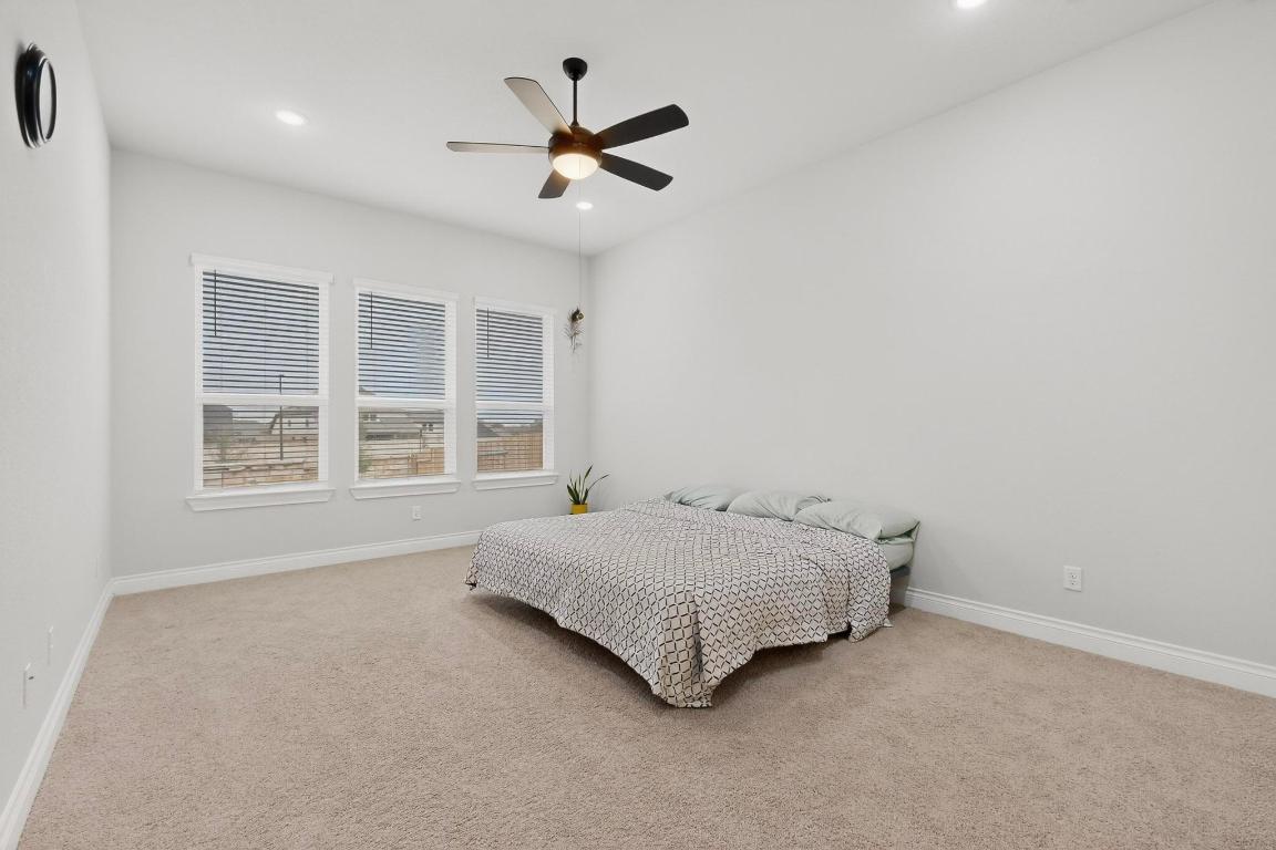 1304 Snowdrop Drive Georgetown, TX 78628 - Photo 11 of 27 a spacious bedroom with a bed and a large window