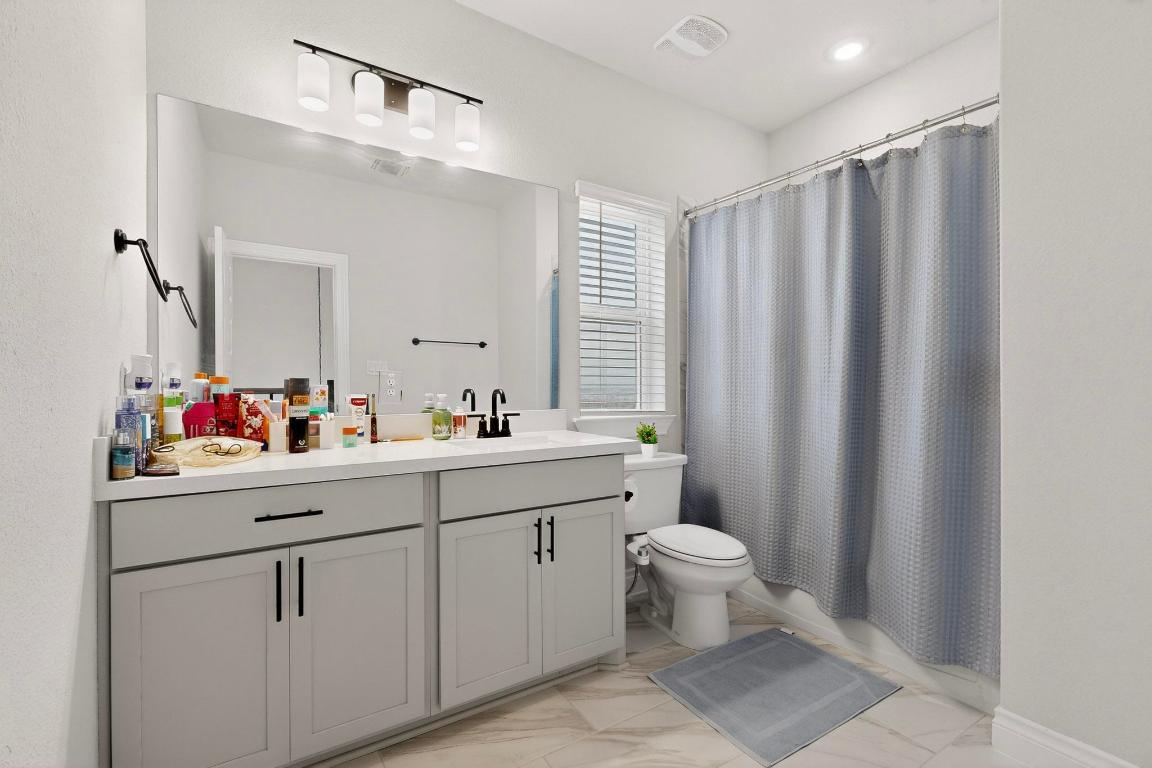 1304 Snowdrop Drive Georgetown, TX 78628 - Photo 16 of 27 a bathroom with a sink toilet and a mirror
