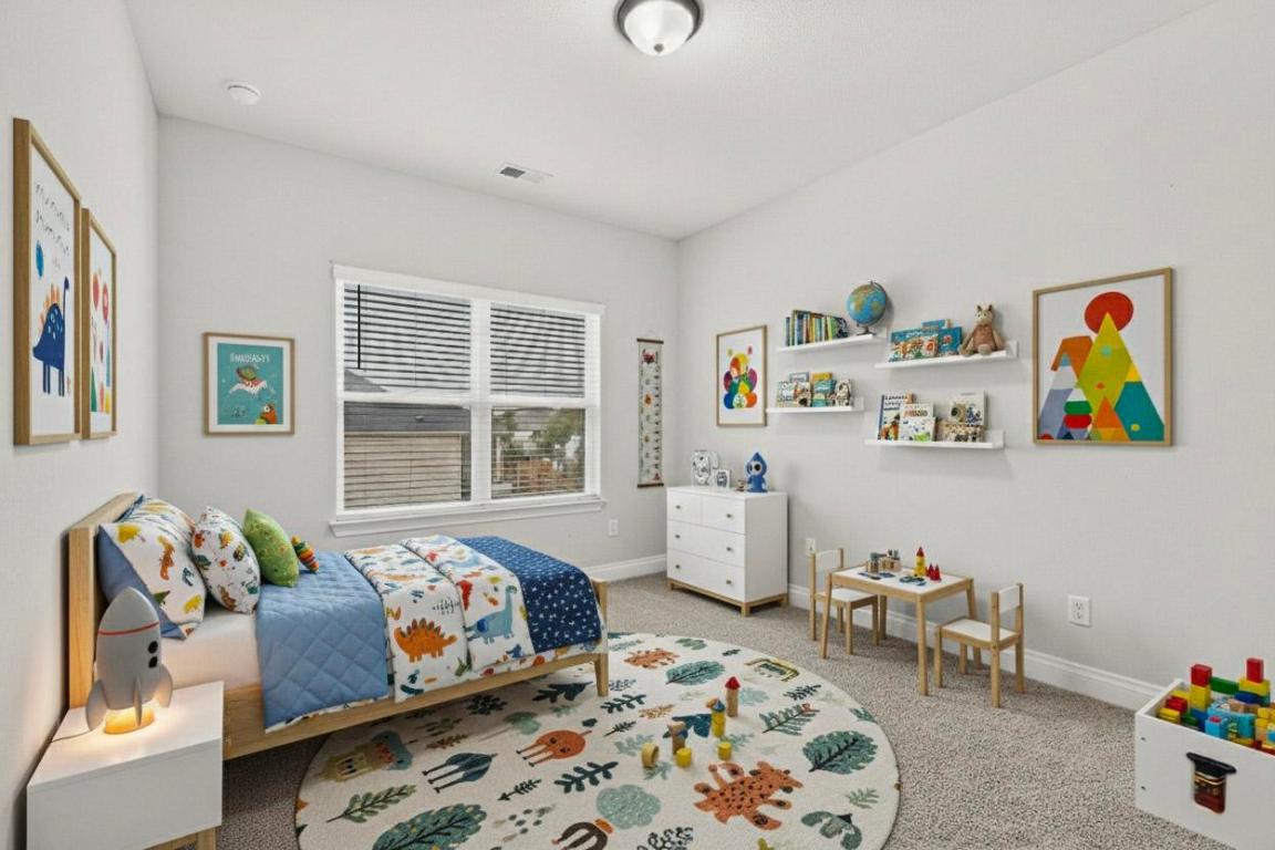 1304 Snowdrop Drive Georgetown, TX 78628 - Photo 19 of 27 a bedroom with bed and wooden floor