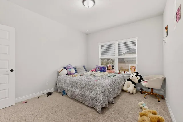 a bedroom with bed and wooden floor