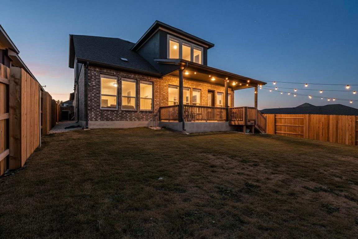 1304 Snowdrop Drive Georgetown, TX 78628 - Photo 24 of 27 a backyard of a house with table and chairs