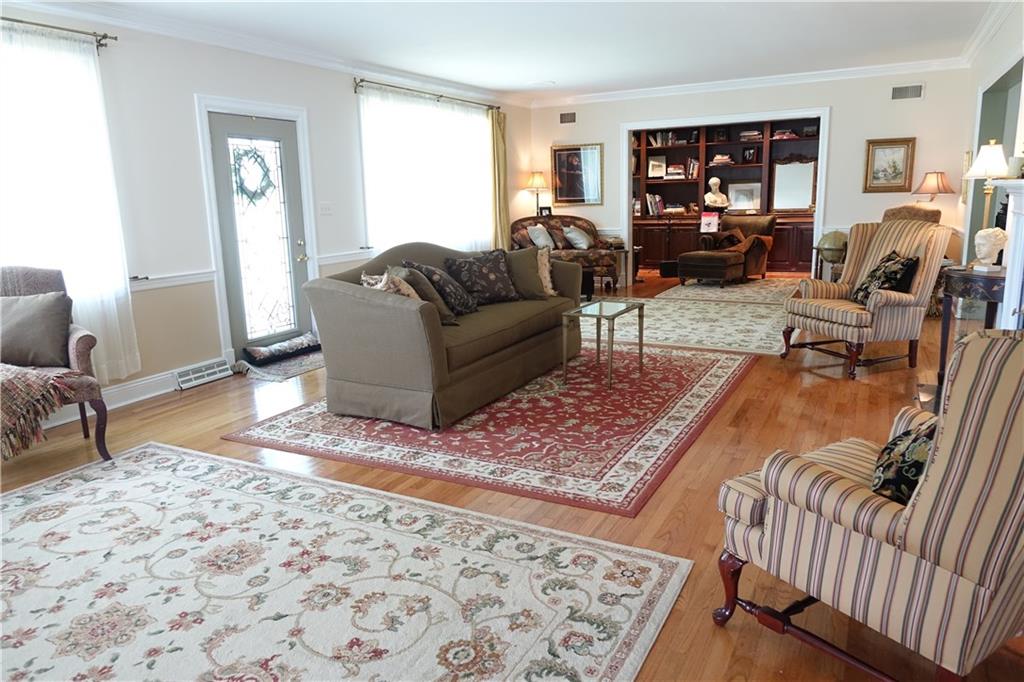 227 Meridian Road Butler, PA 16001 - Photo 2 of 25 Spacious Formal Living Room with hardwood flooring, fireplace, and den area