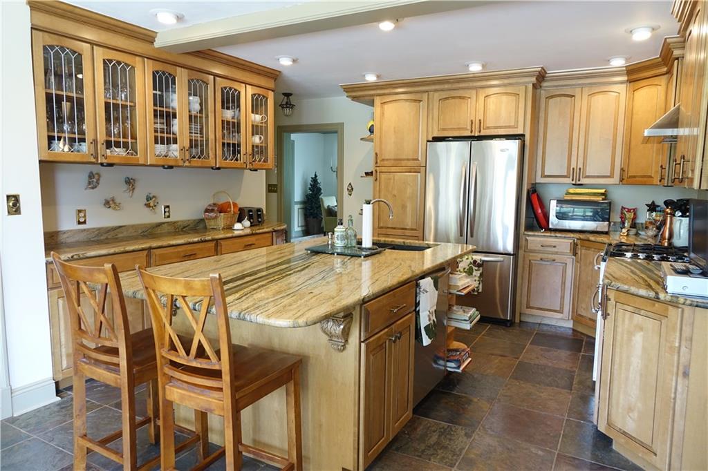 227 Meridian Road Butler, PA 16001 - Photo 6 of 25 Remodeled Eat-in-kitchen with abundant cabinetry, kitchen island, granite counter tops, and stainless steel appliances.