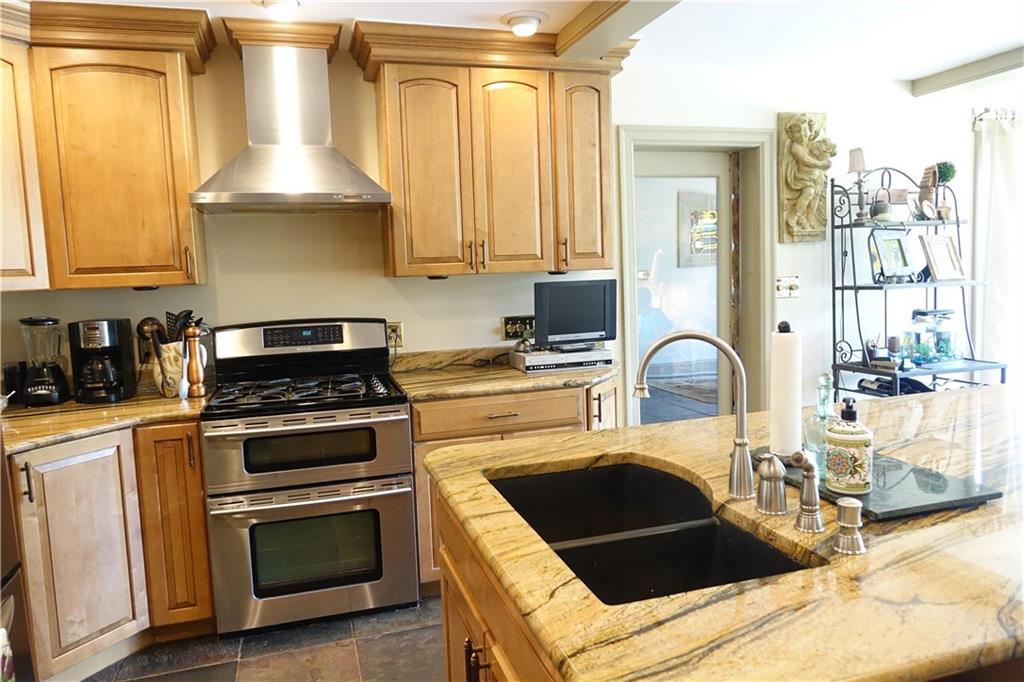 227 Meridian Road Butler, PA 16001 - Photo 7 of 25 Remodeled Eat-in-kitchen with abundant cabinetry, kitchen island, granite counter tops, and stainless steel appliances