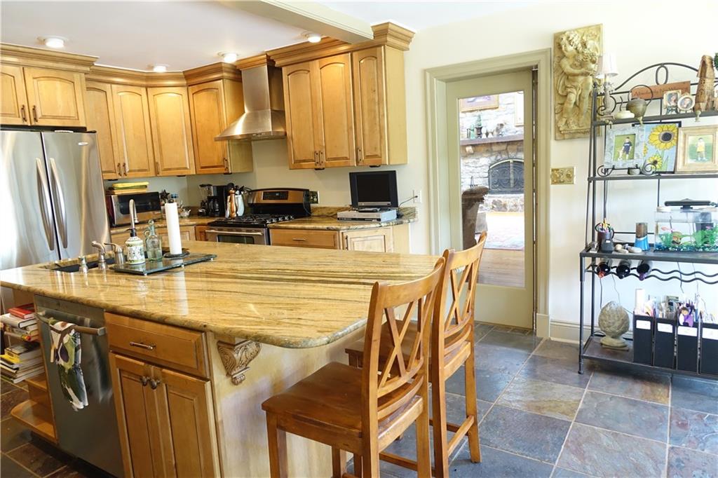 227 Meridian Road Butler, PA 16001 - Photo 8 of 25 Remodeled Eat-in-kitchen with abundant cabinetry, kitchen island, granite counter tops, and stainless steel appliances