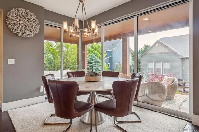 a view of a dining room with furniture wooden floor and chandelier