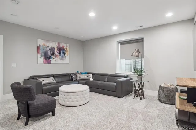 a living room with furniture and a view of kitchen