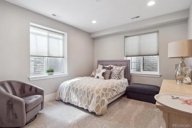 a bedroom with a bed and a couch