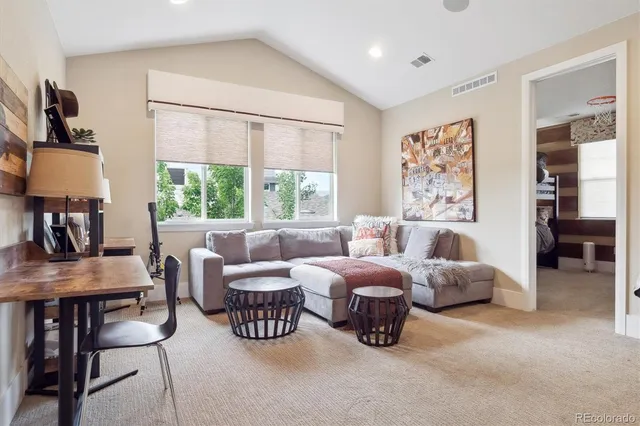 a bedroom with furniture and a large window