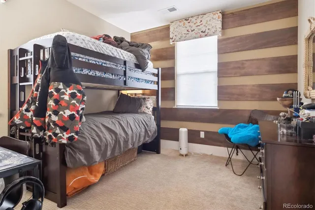 a bedroom with furniture and a potted plant