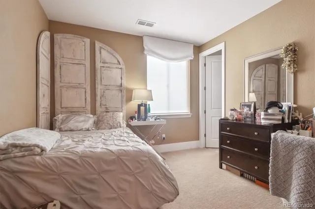 a bedroom with a bed and a dresser