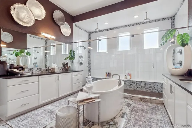 a spacious bathroom with a bathtub sink and mirror